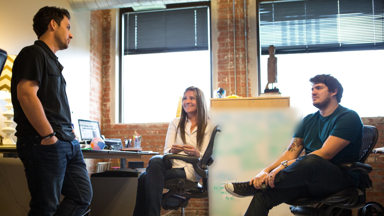 Brandon talking with two Sq1 teammates in the Dallas office, 2012